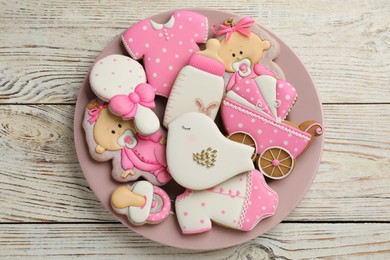 Photo of cUte tasty cookies of different shapes on white wooden table, top view. Baby shower party