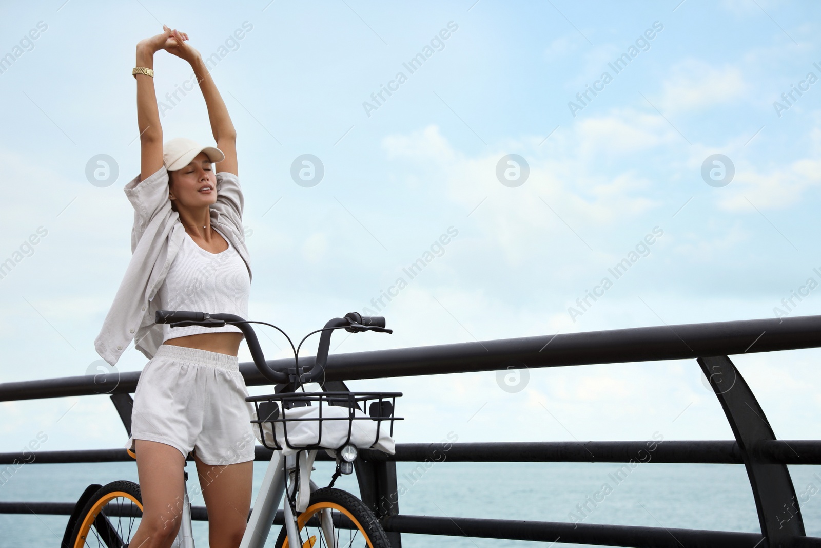 Photo of Beautiful young woman with bicycle near sea. Space for text