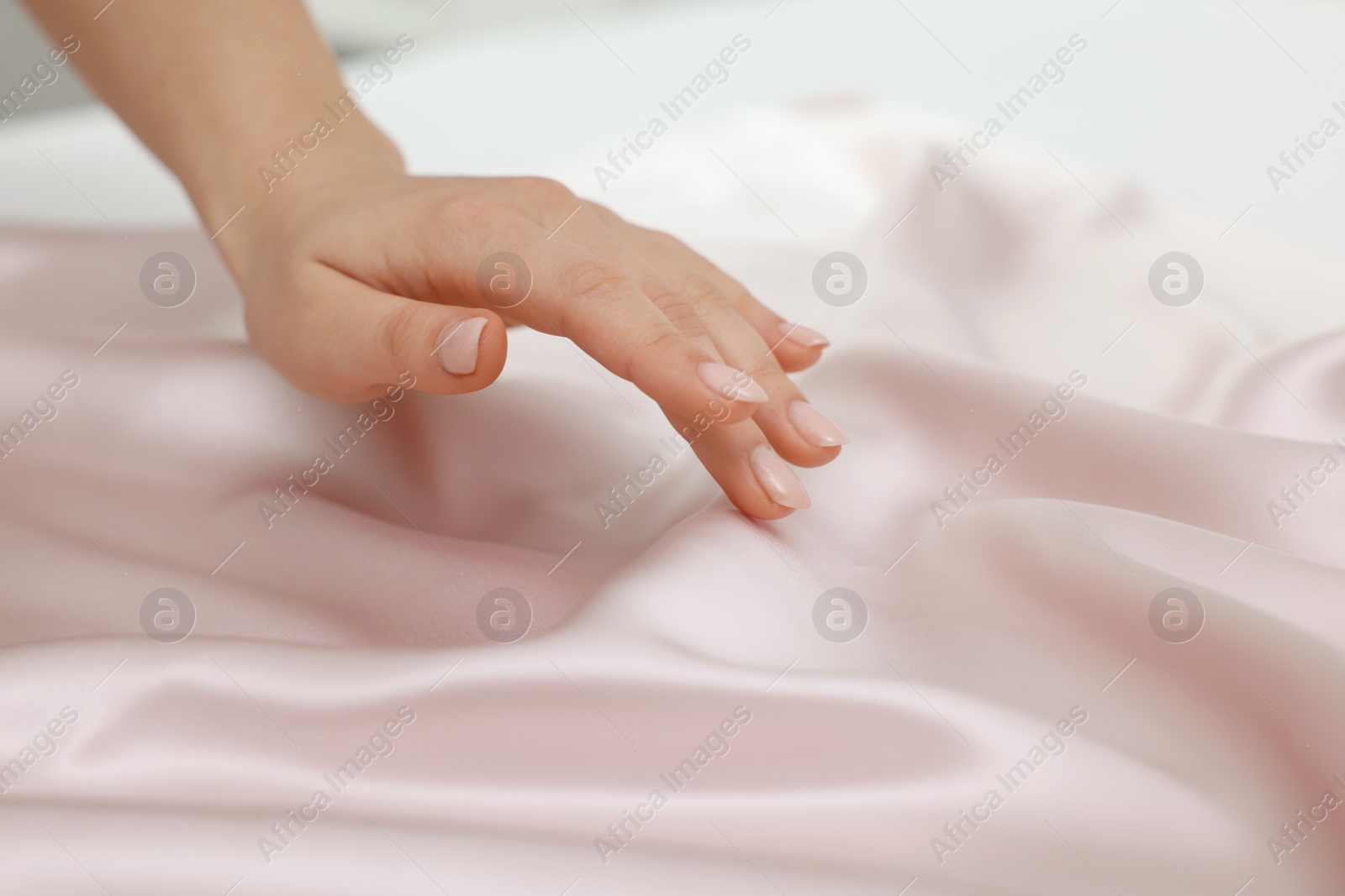 Photo of Woman touching smooth silky fabric, closeup view