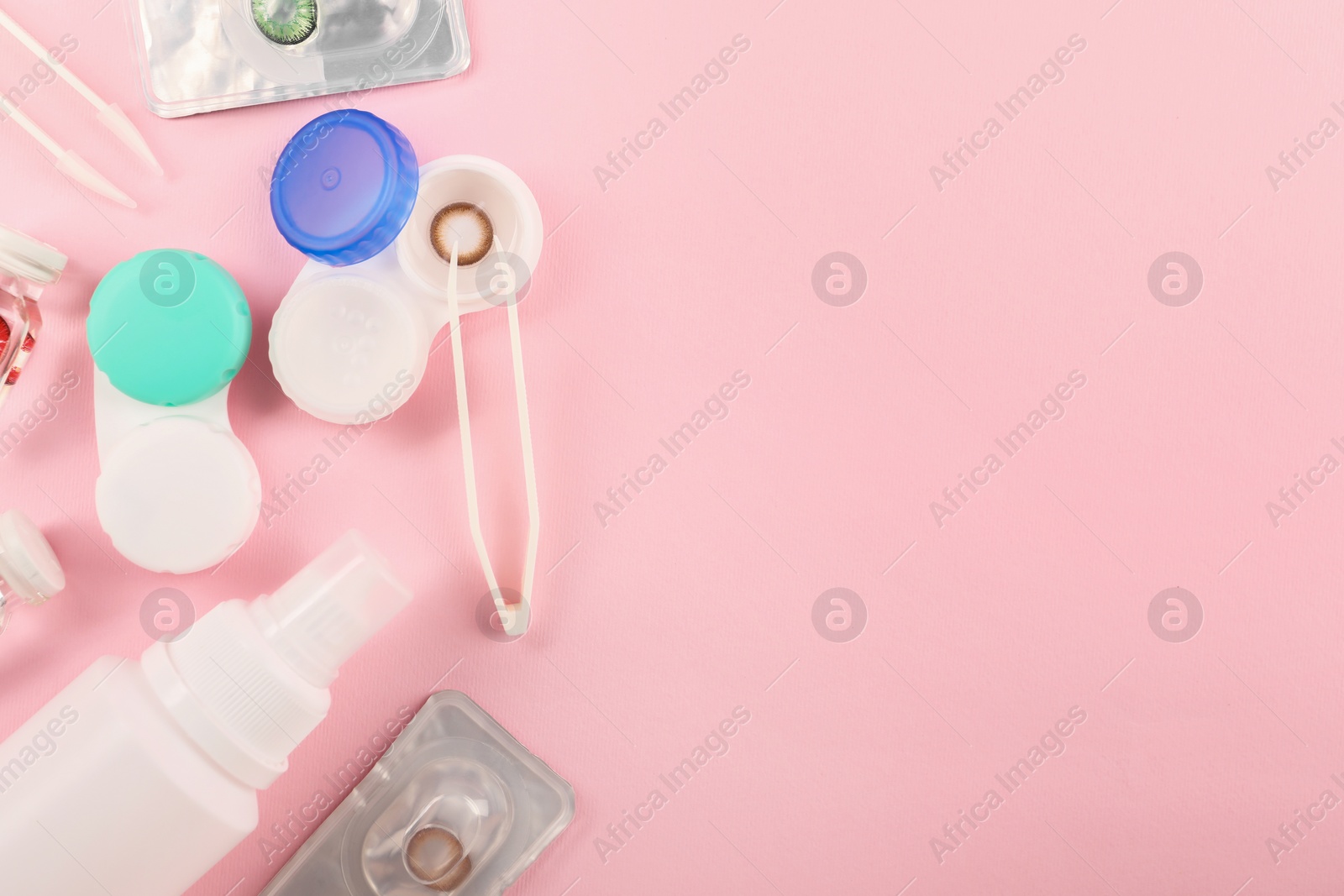 Photo of Flat lay composition with color contact lenses on pink background, space for text