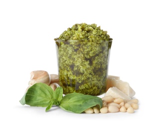 Composition with glass of tasty pesto sauce isolated on white