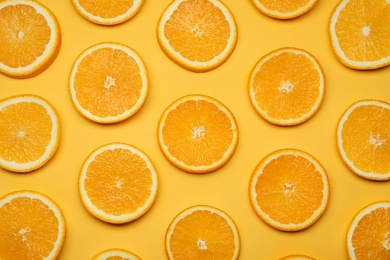 Photo of Fresh orange slices on color background, top view