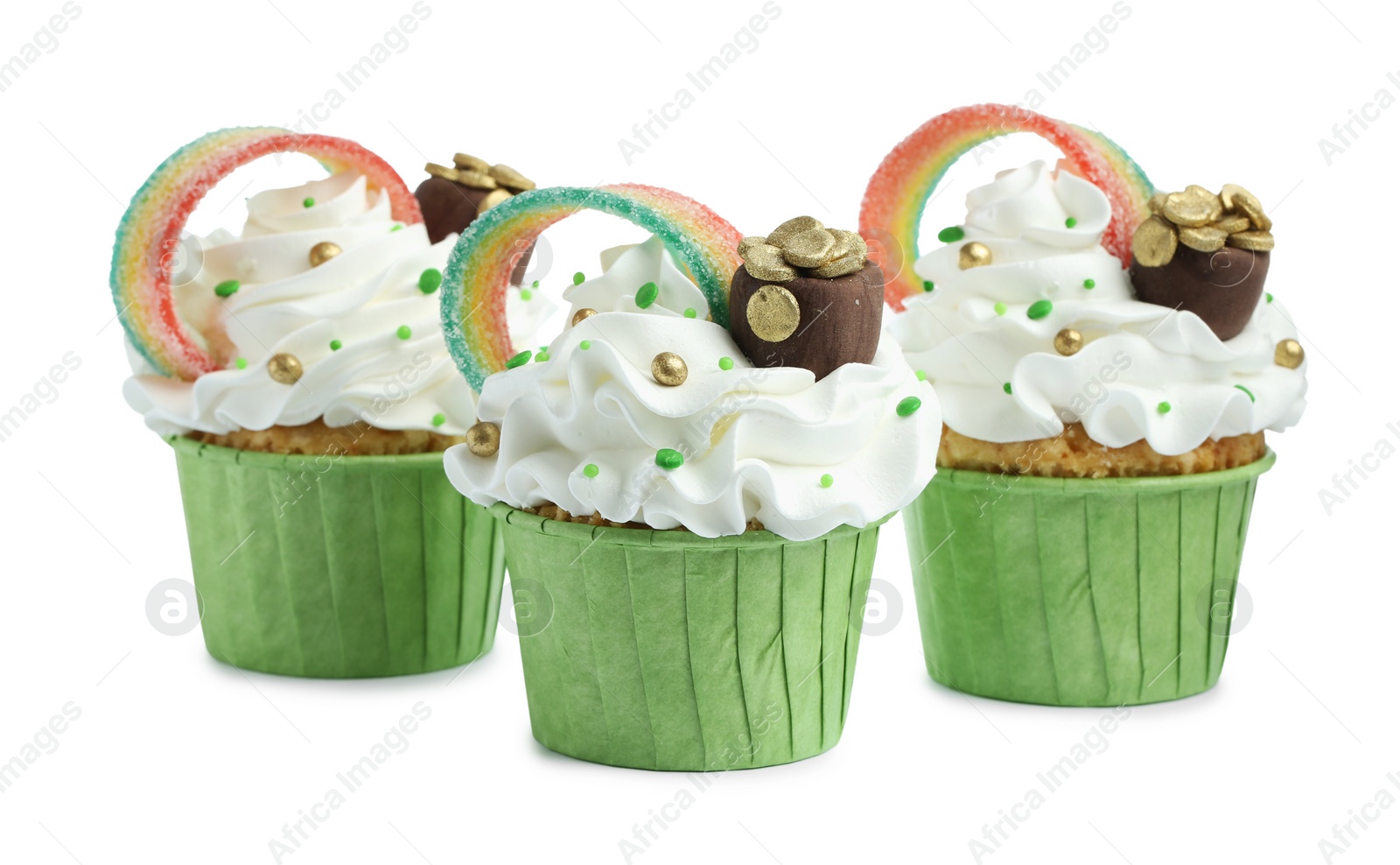 Photo of St. Patrick's day party. Tasty cupcakes with sour rainbow belt and pot of gold toppers isolated on white