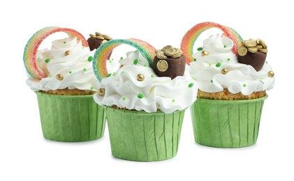 St. Patrick's day party. Tasty cupcakes with sour rainbow belt and pot of gold toppers isolated on white