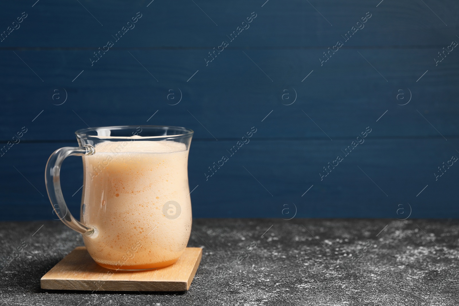 Photo of Delicious eggnog on grey table. Space for text