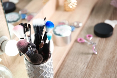 Photo of Holder with professional makeup brushes, closeup