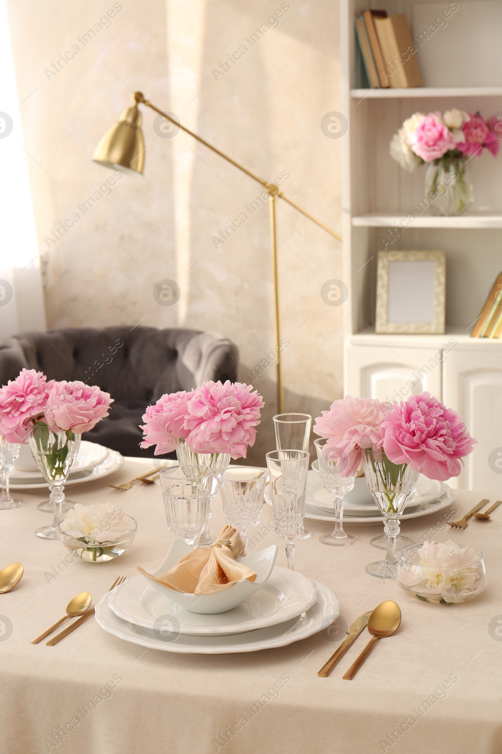 Photo of Stylish table setting with beautiful peonies and fabric napkin indoors