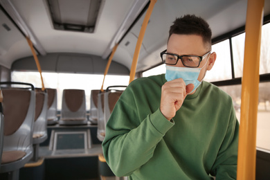 Man with disposable mask on bus. Virus protection