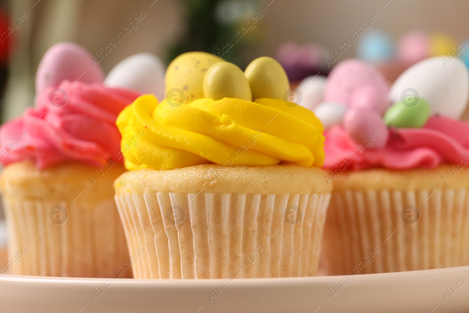 Photo of Tasty decorated Easter cupcakes on table, closeup