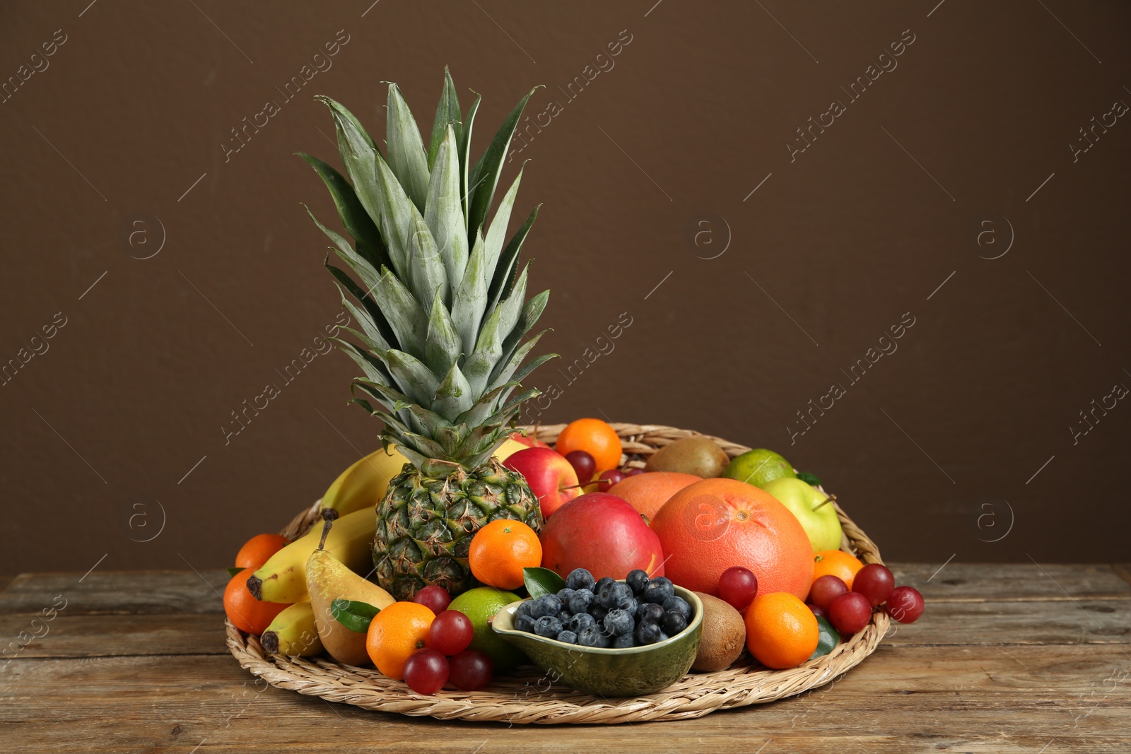 Photo of Assortment of fresh exotic fruits on wooden table