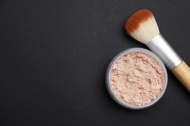 Photo of Face powder and makeup brush on black background, flat lay. Space for text