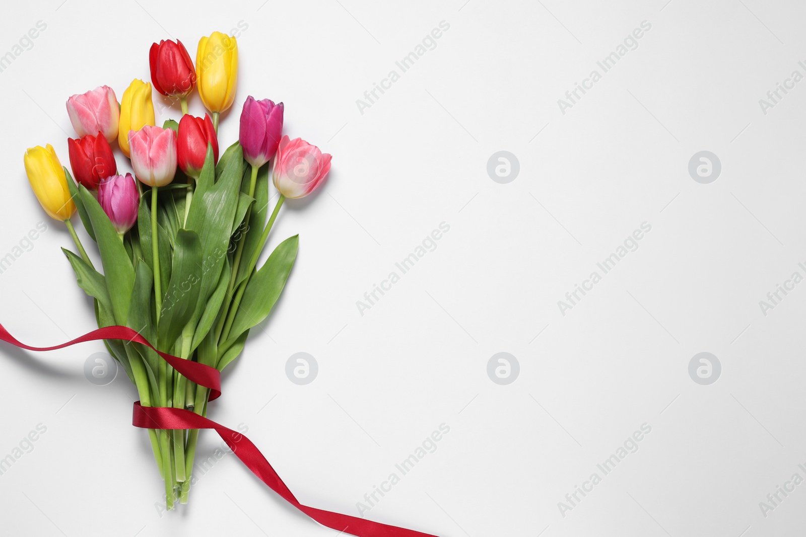 Photo of Beautiful colorful tulips on white background, top view