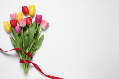 Beautiful colorful tulips on white background, top view