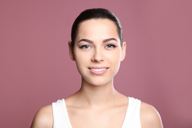 Young woman with sexy lips on color background