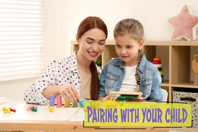 Image of Pairing With Your Child. Mother and her daughter playing together at desk indoors