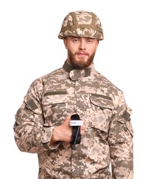 Soldier in military uniform holding medical tourniquet on white background