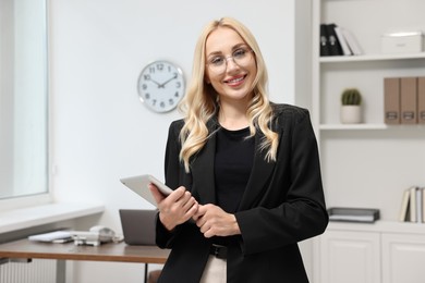 Portrait of happy secretary with tablet in office