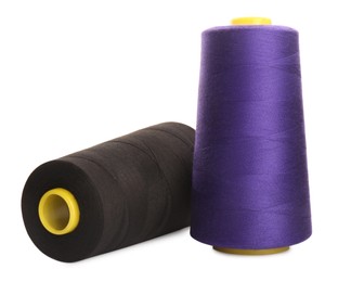 Photo of Different colorful sewing threads on white background