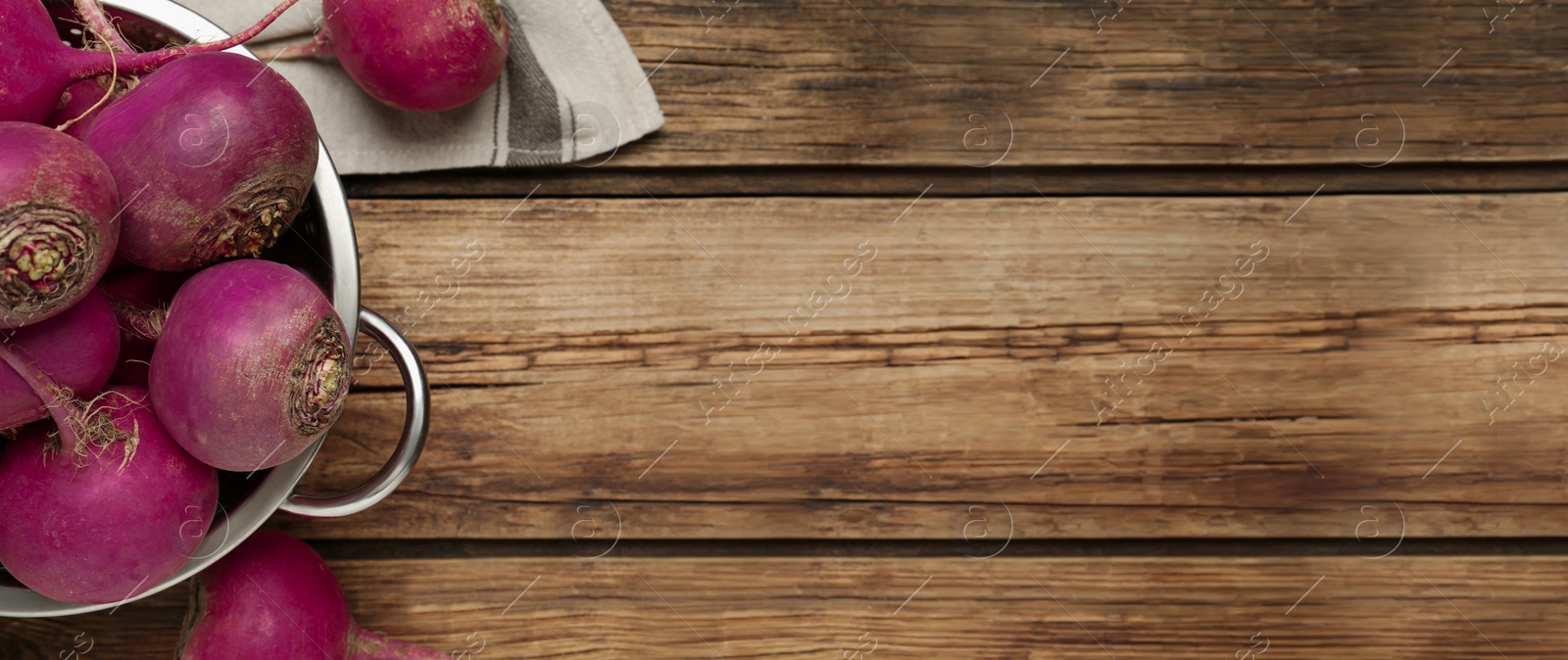 Image of Red turnips on wooden table, flat lay. Space for text