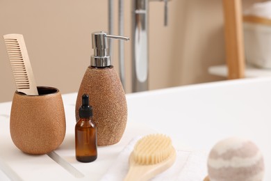 Photo of Different personal care products and accessories on bath tub in bathroom, closeup. Space for text