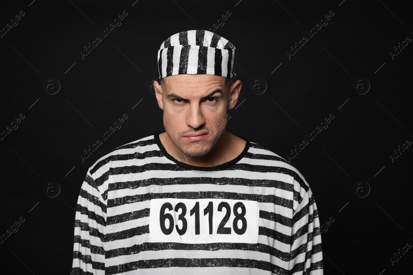 Photo of Prisoner in striped uniform on black background