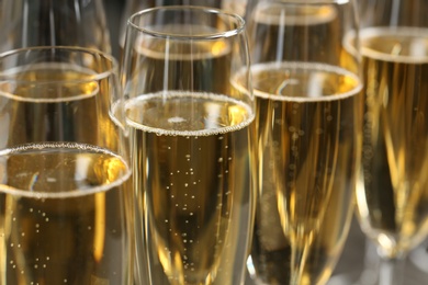 Many glasses of champagne as background, closeup view