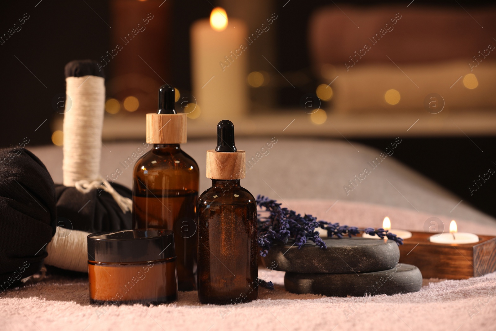 Photo of Composition with spa products and burning candles on soft light surface