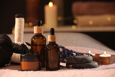 Composition with spa products and burning candles on soft light surface