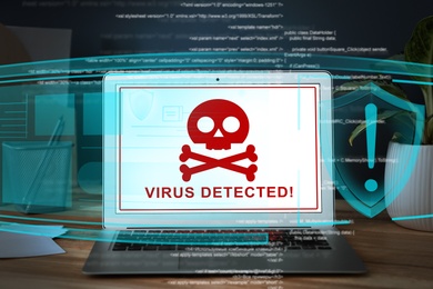 Image of Warning about virus attack on laptop screen. Workplace in office