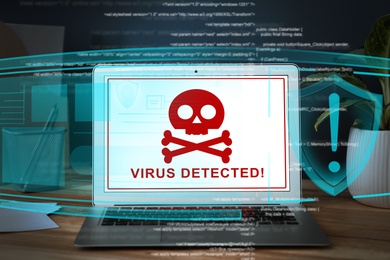 Warning about virus attack on laptop screen. Workplace in office