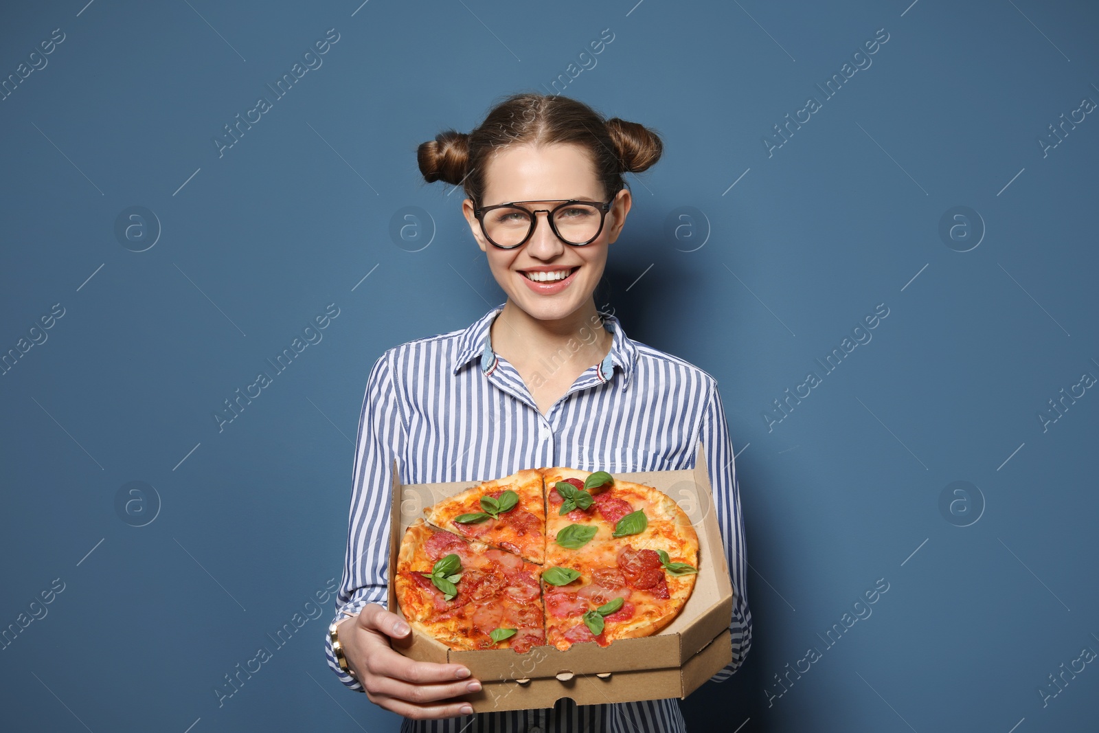 Photo of Attractive young woman with delicious pizza on color background