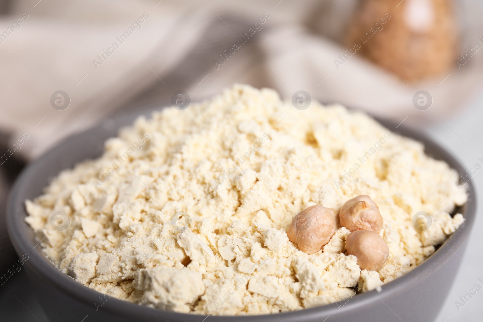 Photo of Chickpea flour and seeds in bowl, closeup