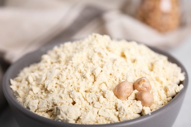 Photo of Chickpea flour and seeds in bowl, closeup