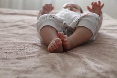 Photo of Little baby on brown blanket indoors, closeup