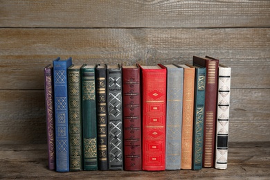 Stack of hardcover books on wooden table