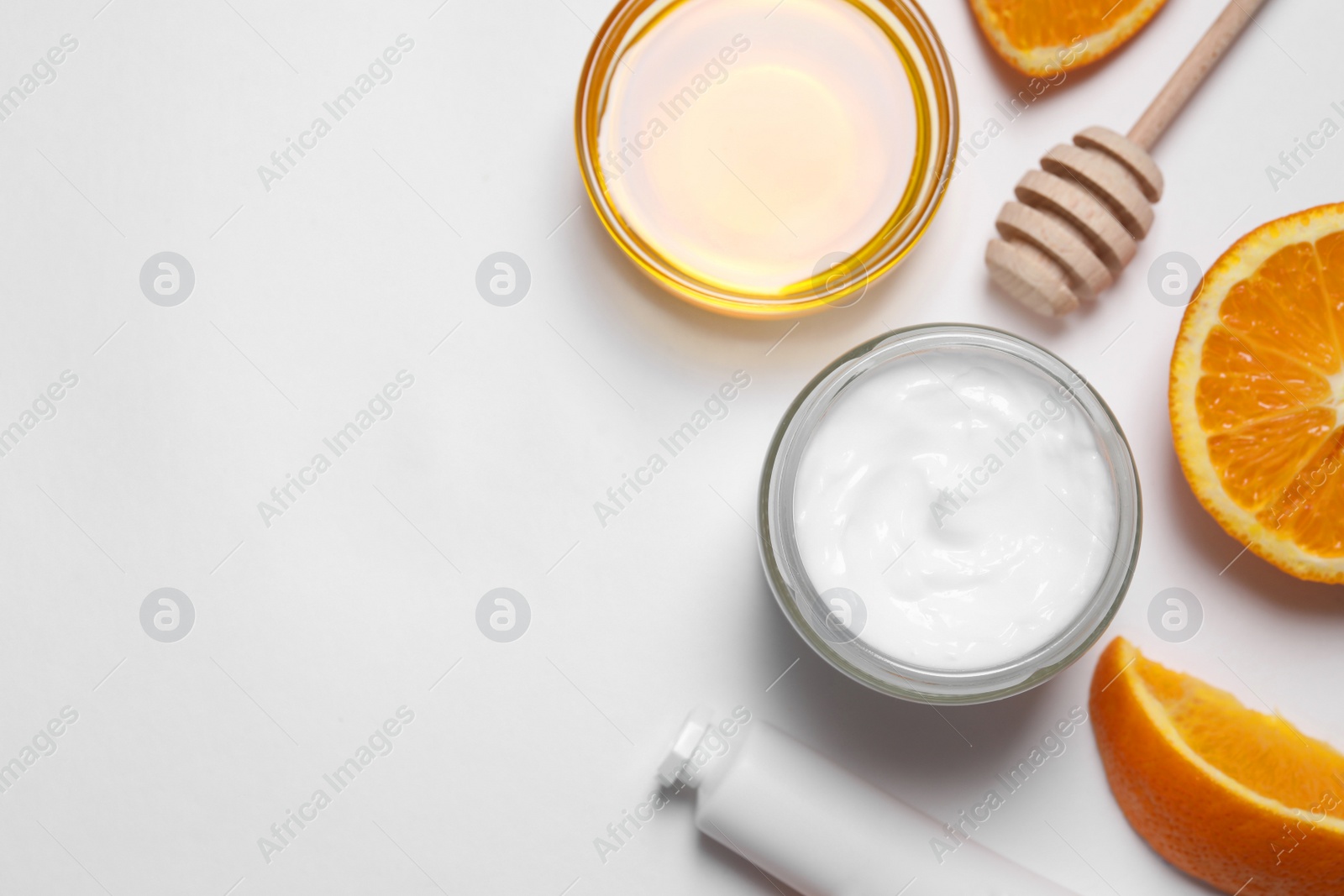 Photo of Different hand care cosmetic products, orange and honey on white background, flat lay. Space for text