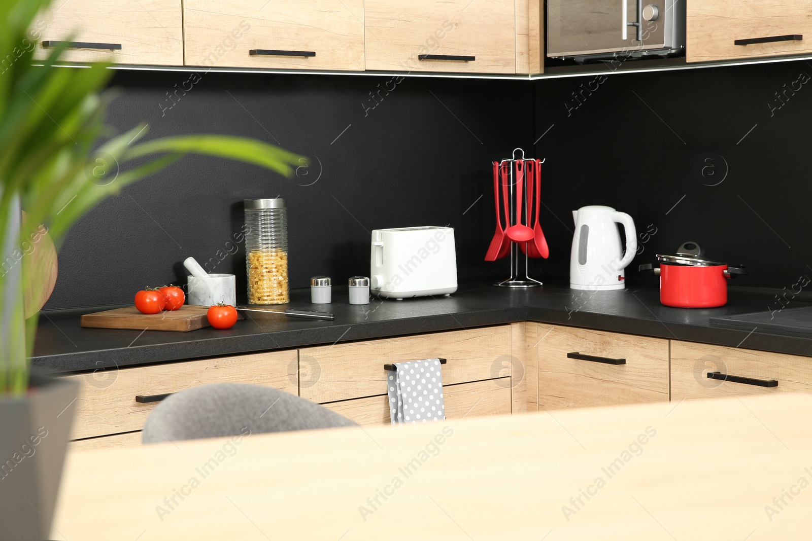 Photo of Kitchen interior with new furniture, appliances and houseware