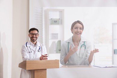 Image of Lecture with online participant. Doctor in meeting room. Using projector for videoconference