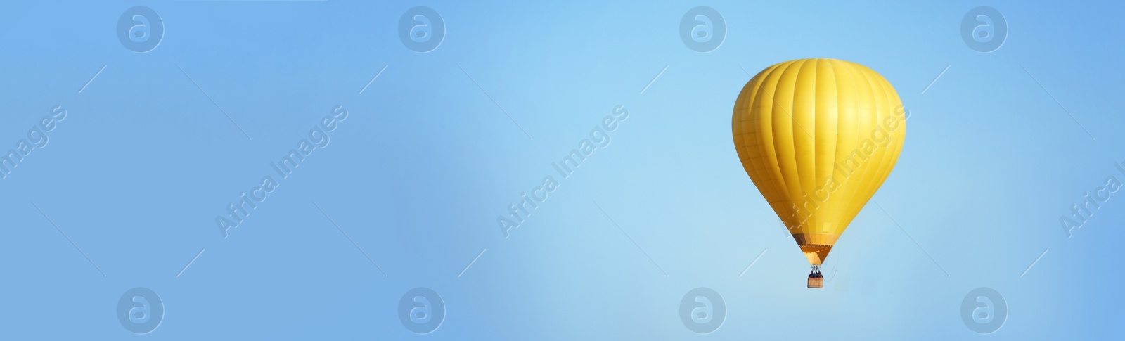 Image of Hot air balloon in blue sky, space for text. Banner design 