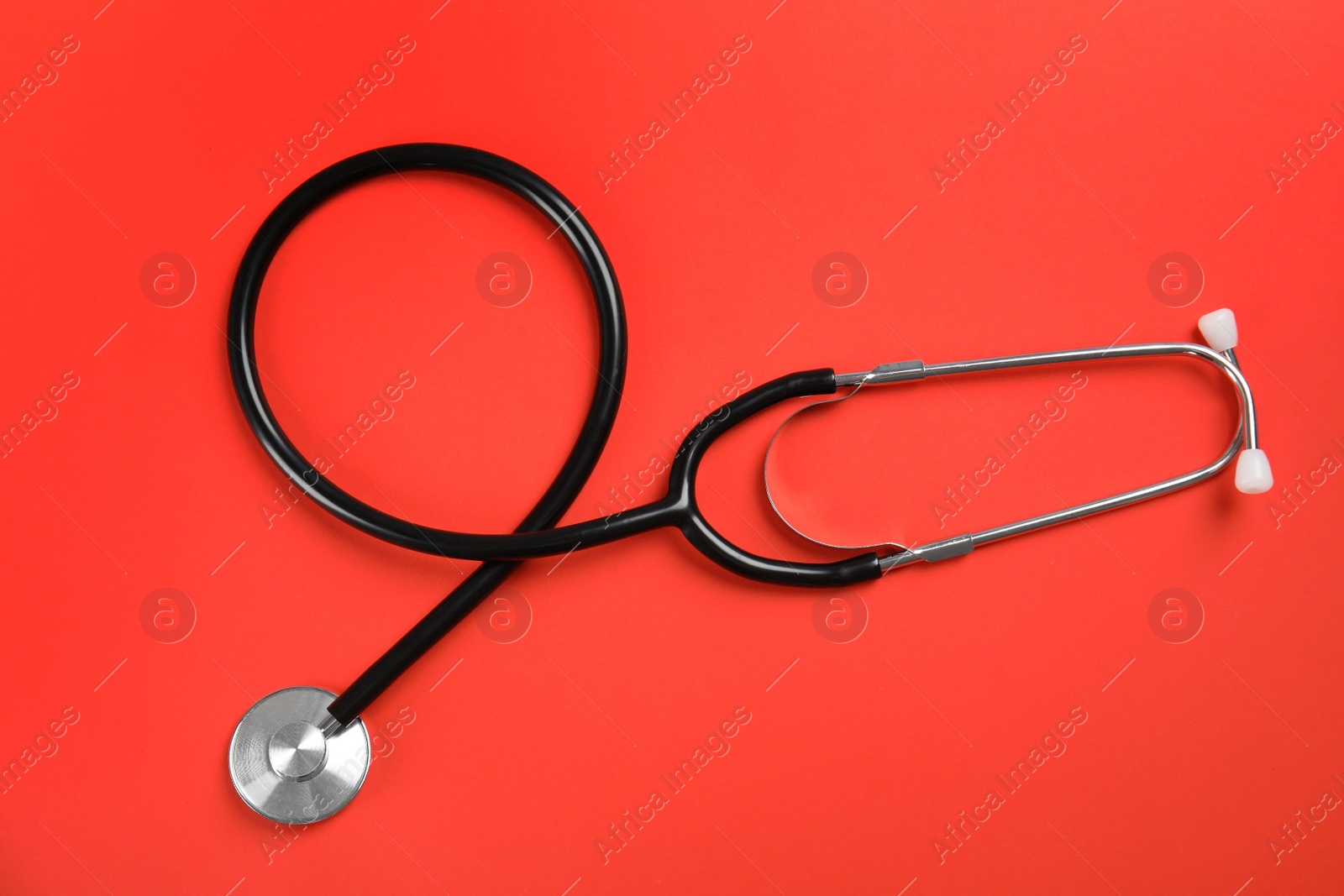 Photo of Stethoscope on color background, top view. Medical tool