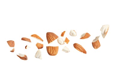 Photo of Pieces of tasty almonds on white background