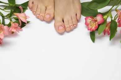 Photo of Closeup of woman with neat toenails after pedicure procedure on white background, top view. Space for text