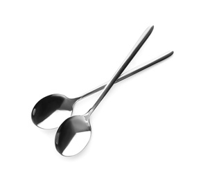 Photo of Clean shiny metal spoons on white background