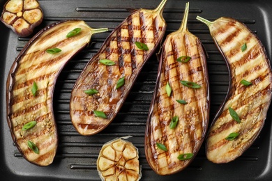 Delicious grilled eggplant halves in pan, closeup