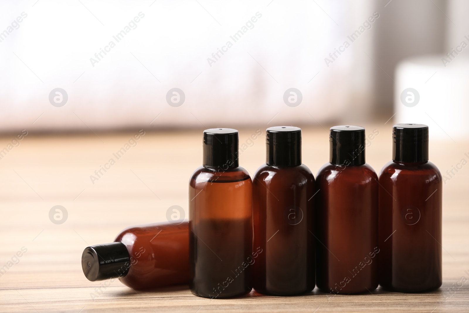 Photo of Mini bottles with cosmetic products on table. Hotel amenities