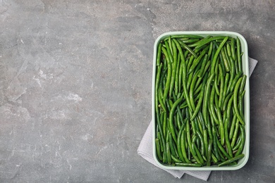 Photo of Dish with tasty green beans on table, top view