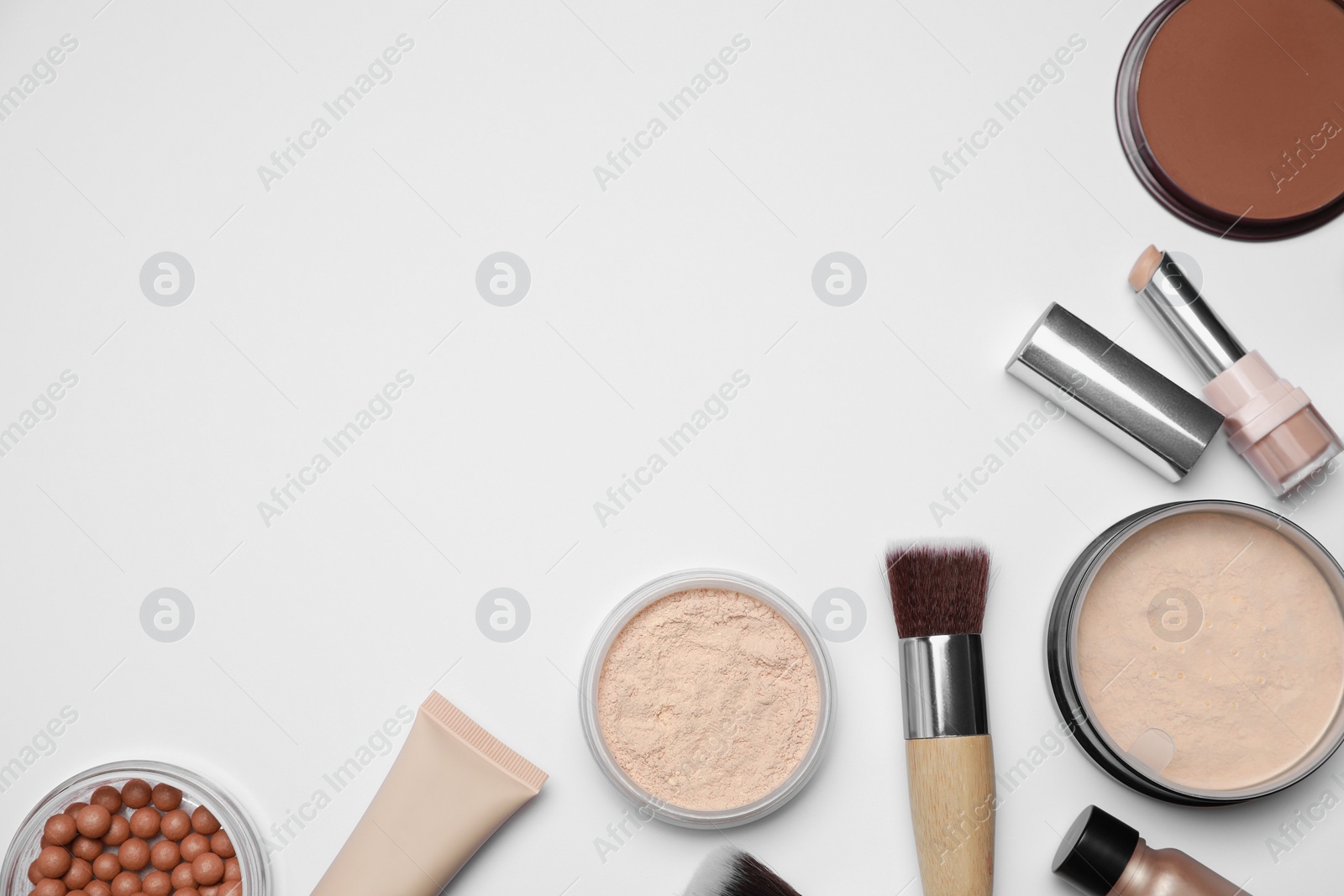 Photo of Face powders and other makeup products on white background, flat lay. Space for text