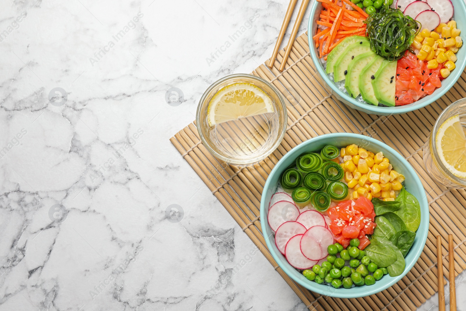 Photo of Delicious salad with salmon and vegetables served on white marble table, flat lay. Space for text