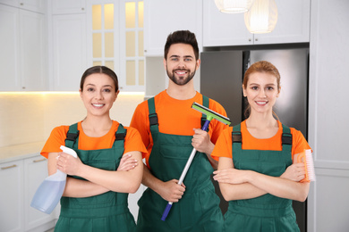 Photo of Team of professional janitors in kitchen. Cleaning service