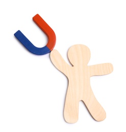 Photo of Red and blue horseshoe magnet with wooden human figure on white background, top view